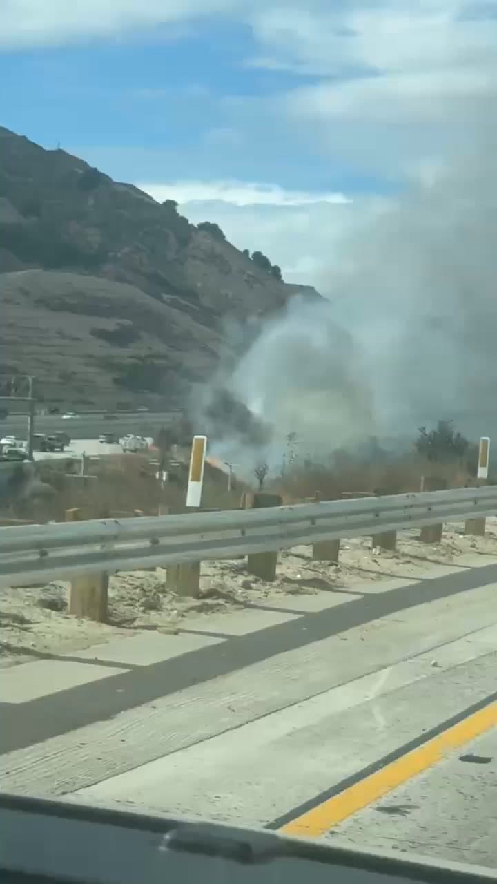 Car fire at the 14/5 north interchange, gray Toyota Camry fully engulfed, fire spreading to brush · CHP and FD enroute code 3